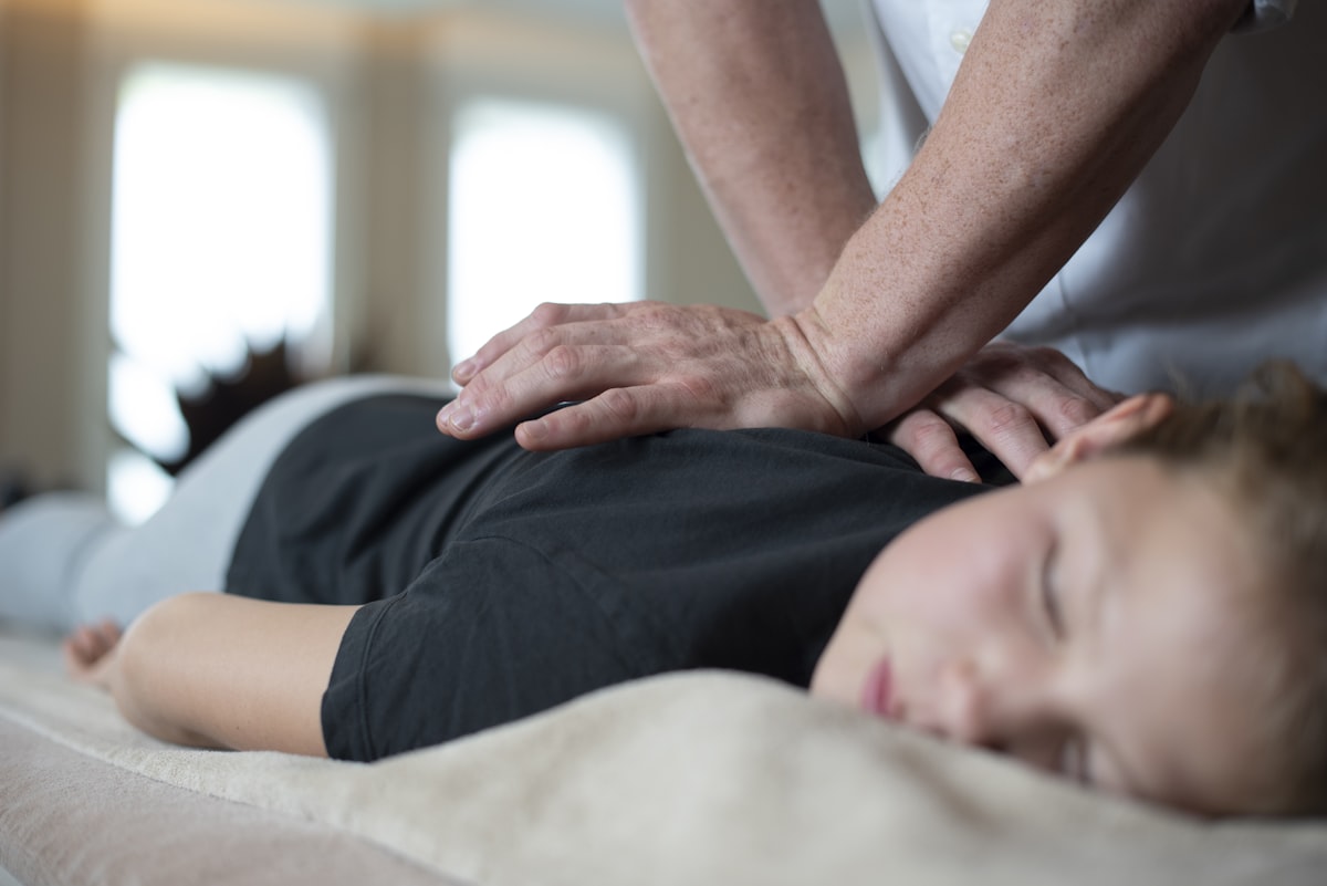 Terapeuta wykonuje technikę metody McKenziego na kręgosłupie pacjenta